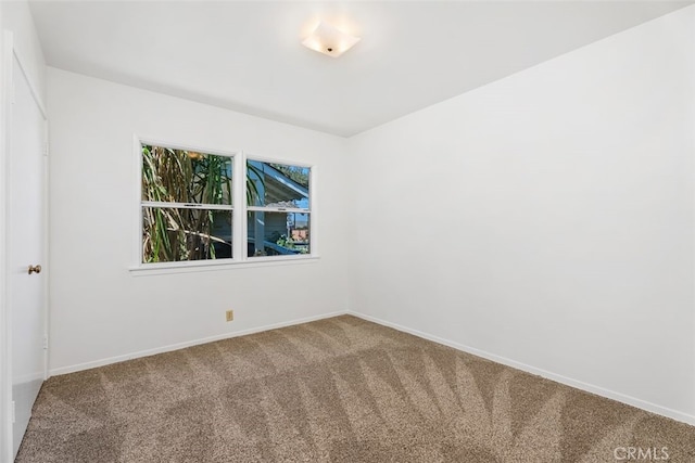 carpeted spare room with baseboards