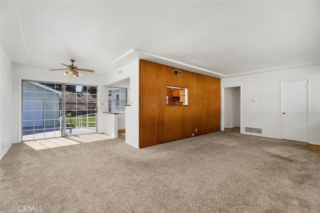 unfurnished living room featuring a ceiling fan, carpet flooring, and baseboards