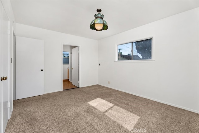 unfurnished bedroom with carpet and baseboards
