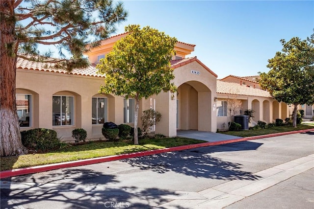 43473 30th St W Unit 4, Lancaster, CA 93536 - mediterranean / spanish house featuring stucco siding, a tiled roof, and cooling unit