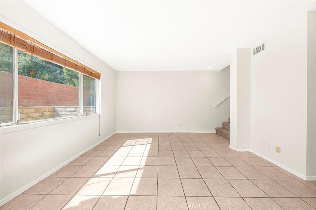 43473 30th St W Unit 4, Lancaster, CA 93536 - unfurnished room featuring light tile patterned flooring, stairs, and baseboards