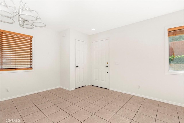 43473 30th St W Unit 4, Lancaster, CA 93536 - empty room with a chandelier, baseboards, light tile patterned floors, and recessed lighting