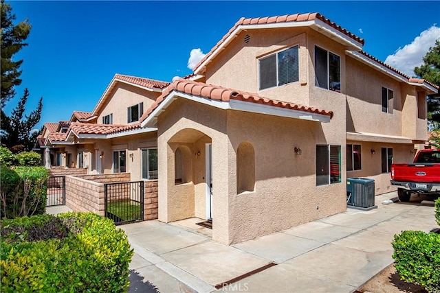 43473 30th St W Unit 4, Lancaster, CA 93536 - mediterranean / spanish-style house featuring cooling unit, stucco siding, a tiled roof, and fence