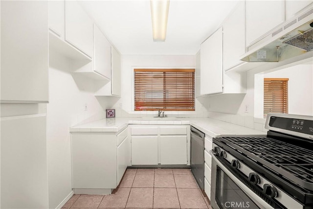 43473 30th St W Unit 4, Lancaster, CA 93536 - kitchen with appliances with stainless steel finishes, under cabinet range hood, a sink, white cabinets, and light tile patterned floors