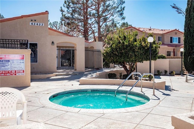 43473 30th St W Unit 4, Lancaster, CA 93536 - view of swimming pool with a hot tub and fence