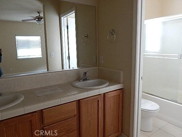 615 Vallecito Way, Red Bluff, CA 96080 - full bath featuring tile patterned floors, toilet, ceiling fan, double vanity, and bathtub / shower combination