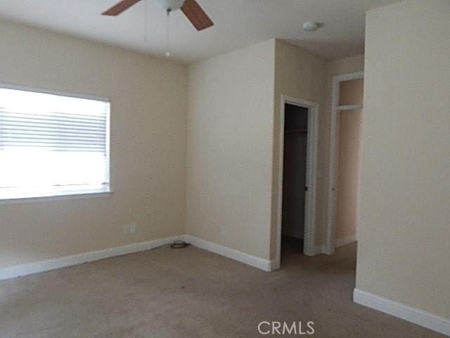 615 Vallecito Way, Red Bluff, CA 96080 - unfurnished bedroom with light carpet, baseboards, and ceiling fan