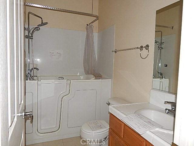 615 Vallecito Way, Red Bluff, CA 96080 - full bath with toilet, shower / bath combo with shower curtain, vanity, and tile patterned floors