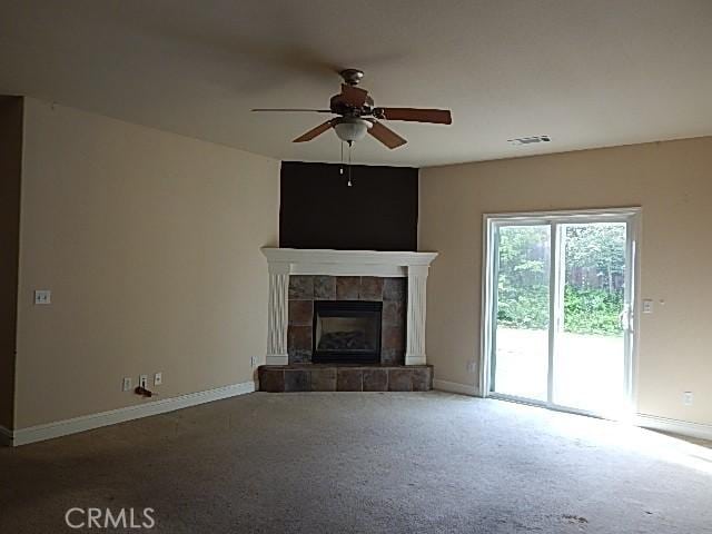 615 Vallecito Way, Red Bluff, CA 96080 - unfurnished living room featuring a ceiling fan, baseboards, carpet flooring, and a tiled fireplace