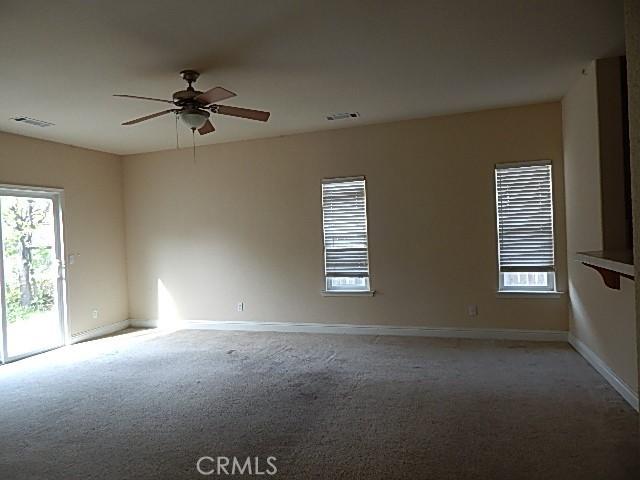 615 Vallecito Way, Red Bluff, CA 96080 - empty room featuring light colored carpet, plenty of natural light, and a ceiling fan
