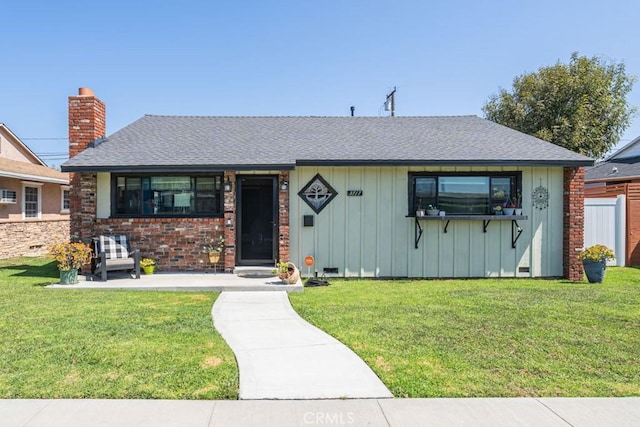 3717 W 182nd St, Torrance, CA 90504 - view of front of house featuring a front lawn, board and batten siding, a shingled roof, and brick siding