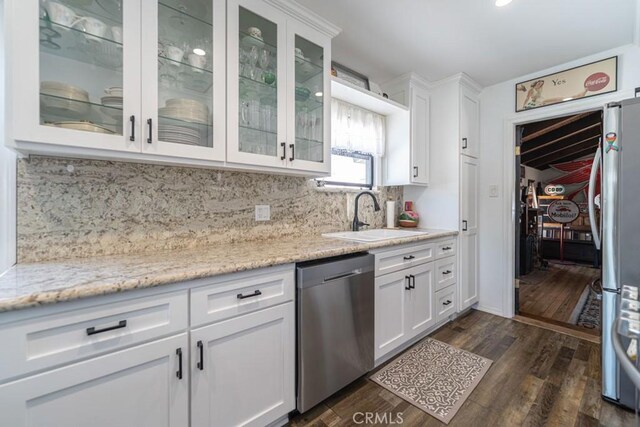 3717 W 182nd St, Torrance, CA 90504 - kitchen featuring appliances with stainless steel finishes, white cabinets, tasteful backsplash, dark wood-style floors, and light stone counters