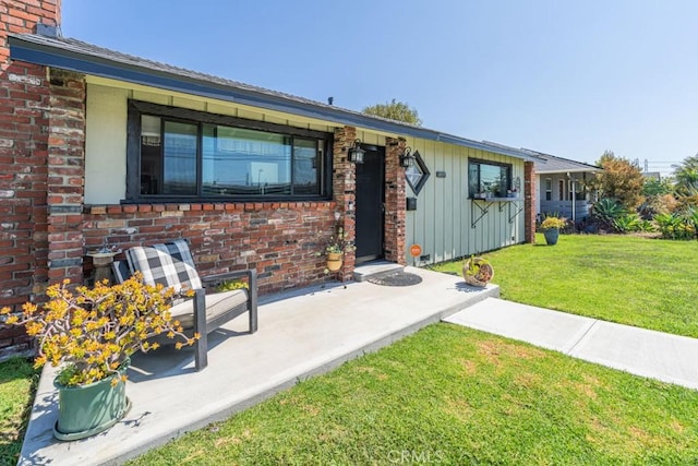3717 W 182nd St, Torrance, CA 90504 - view of front facade featuring a front lawn, brick siding, and board and batten siding
