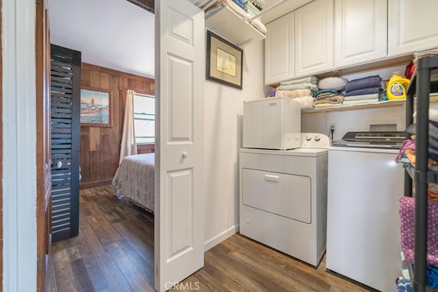 3717 W 182nd St, Torrance, CA 90504 - washroom featuring cabinet space, separate washer and dryer, dark wood-style flooring, and wood walls