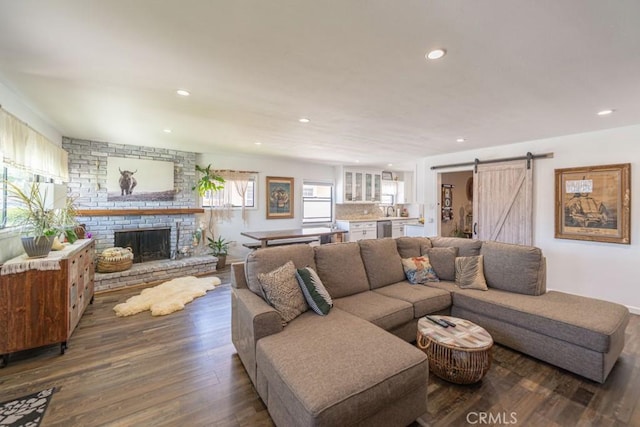 3717 W 182nd St, Torrance, CA 90504 - living room with wood finished floors, recessed lighting, a barn door, and a brick fireplace