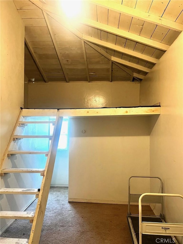 below grade area featuring wooden ceiling and carpet flooring