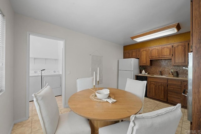 5426 Dwight St, San Diego, CA 92105 - dining area featuring washing machine and dryer and light tile patterned floors