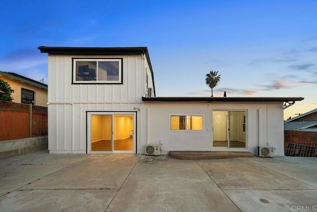 5426 Dwight St, San Diego, CA 92105 - back of property at dusk with a patio area, board and batten siding, and a fenced backyard