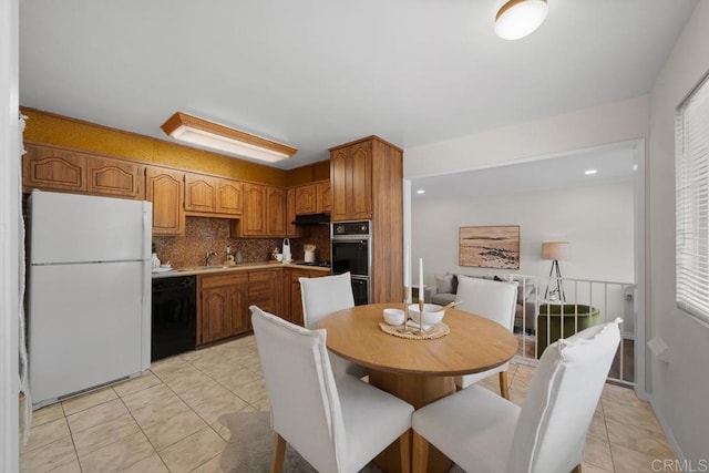5426 Dwight St, San Diego, CA 92105 - kitchen featuring black appliances, tasteful backsplash, brown cabinets, and light tile patterned floors