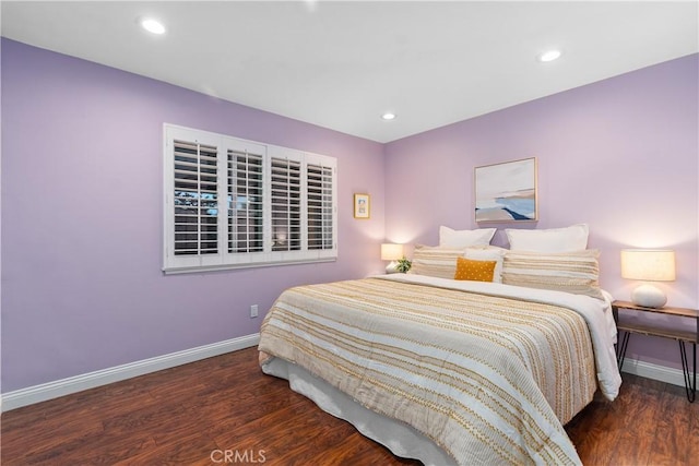 bedroom featuring wood finished floors, baseboards, and recessed lighting