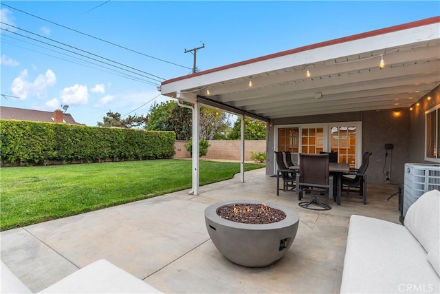 view of patio / terrace with outdoor dining area and a fire pit