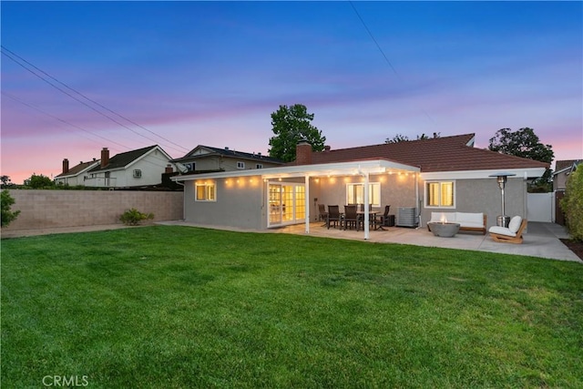 rear view of property with a patio, stucco siding, a chimney, an outdoor living space, and central air condition unit