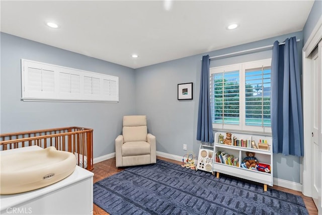 bedroom featuring baseboards, recessed lighting, and wood finished floors