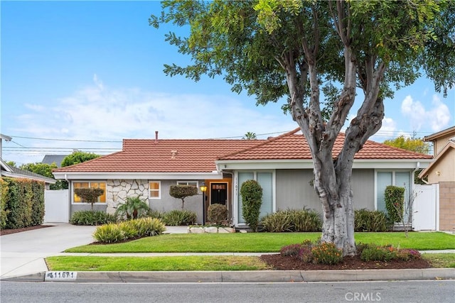 ranch-style home with a tiled roof
