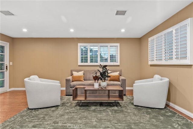 living room featuring wood finished floors, baseboards, and recessed lighting