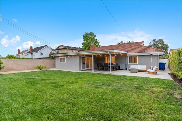 back of property with an outdoor living space, a patio, a chimney, and stucco siding