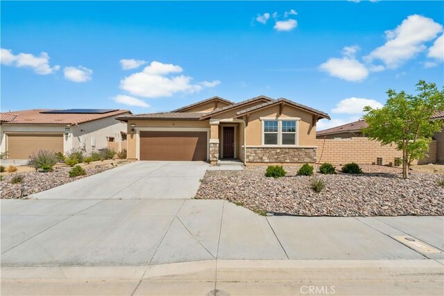 37732 Phelan Ln, Palmdale, CA 93552 - ranch-style house featuring stucco siding, stone siding, an attached garage, driveway, and fence