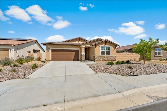 37732 Phelan Ln, Palmdale, CA 93552 - view of front of home with stucco siding, an attached garage, stone siding, concrete driveway, and fence