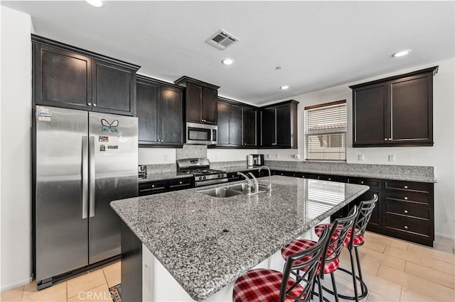 37732 Phelan Ln, Palmdale, CA 93552 - kitchen with appliances with stainless steel finishes, a sink, stone counters, a breakfast bar area, and recessed lighting