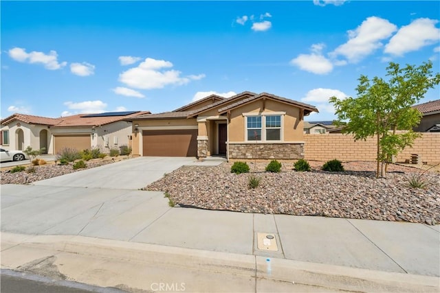 37732 Phelan Ln, Palmdale, CA 93552 - view of front of home with stucco siding, fence, stone siding, driveway, and a garage
