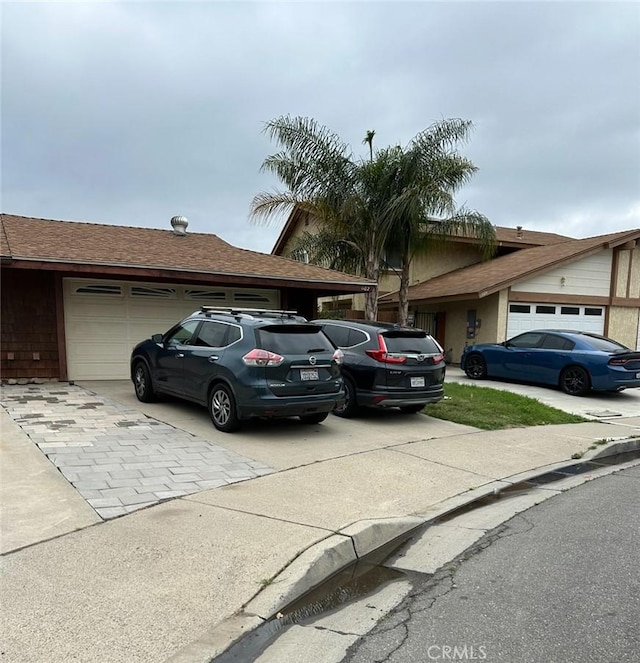1102 Monroe St, Lake Elsinore, CA 92530 - view of front of house featuring driveway and an attached garage