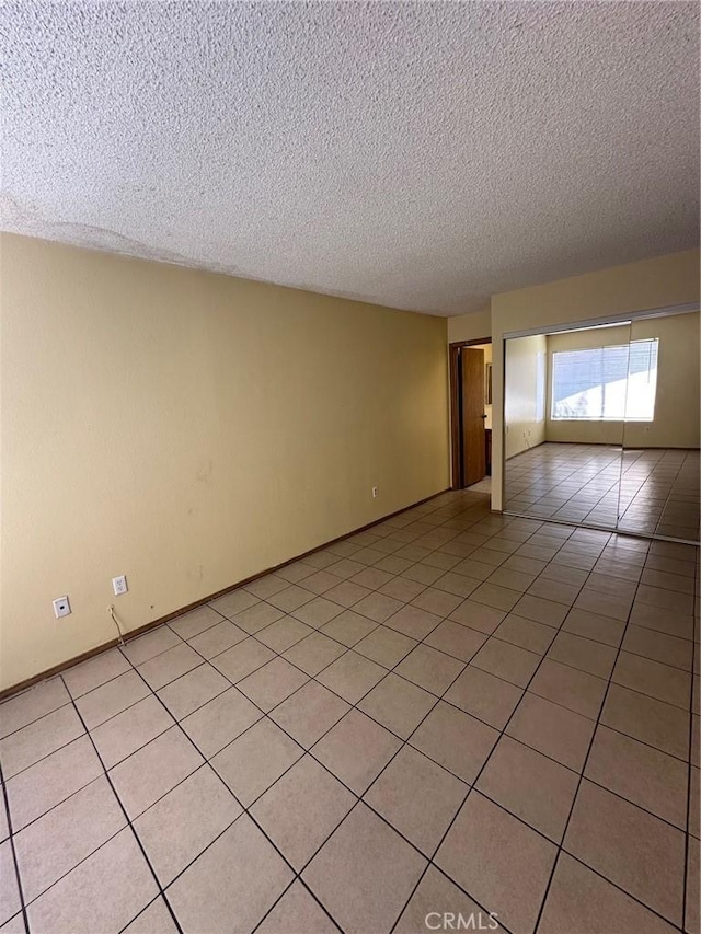 1102 Monroe St, Lake Elsinore, CA 92530 - empty room featuring a textured ceiling and light tile patterned floors