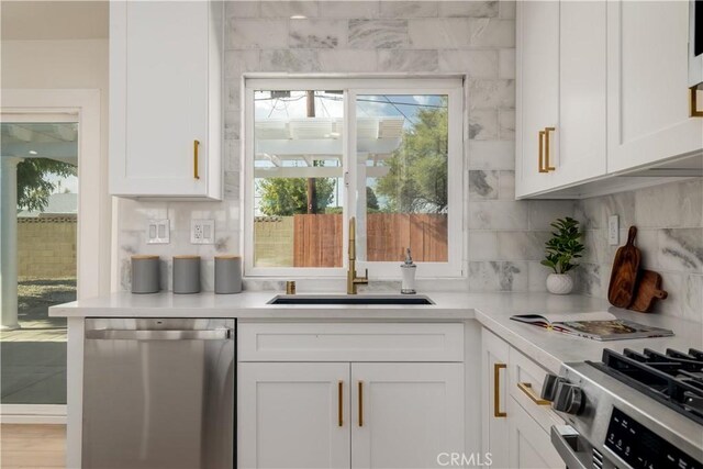 bar with appliances with stainless steel finishes, a sink, and decorative backsplash