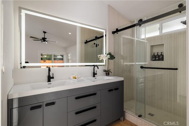 bathroom featuring a shower stall, lofted ceiling, ceiling fan, and double vanity
