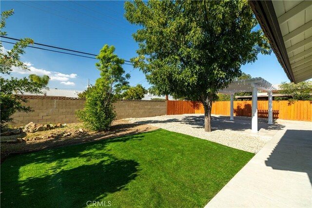 view of yard with a pergola and a patio area
