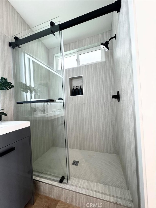 full bathroom with a stall shower and vanity