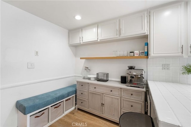 9735 Reseda Blvd Unit 56, Northridge, CA 91324 - kitchen with tile counters, open shelves, decorative backsplash, light wood-style floors, and recessed lighting