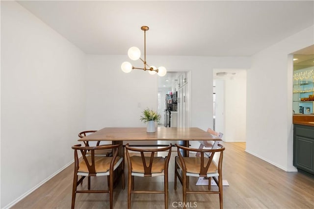 9735 Reseda Blvd Unit 56, Northridge, CA 91324 - dining space featuring light wood-style flooring, a chandelier, and baseboards