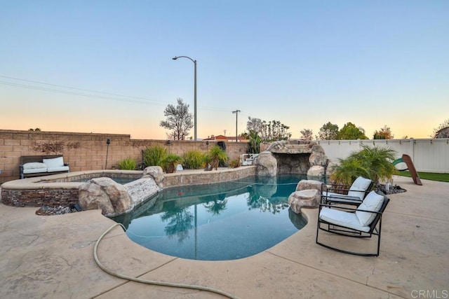 view of swimming pool with an in-ground hot tub, a fenced backyard, and a patio area