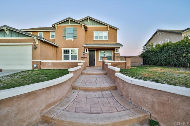 view of front of home with stucco siding, board and batten siding, an attached garage, and fence
