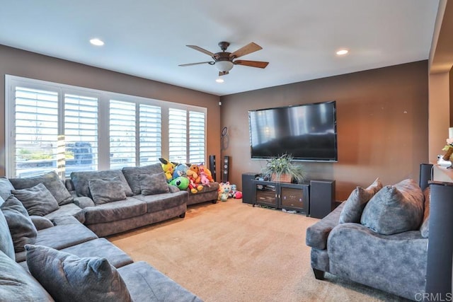 carpeted living area with ceiling fan and recessed lighting