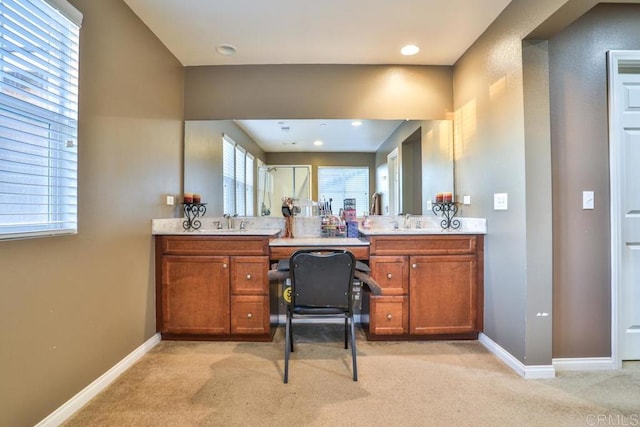 full bathroom with double vanity, carpet flooring, and baseboards