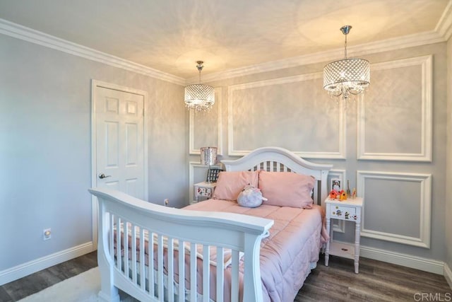bedroom featuring a chandelier, wood finished floors, baseboards, and crown molding