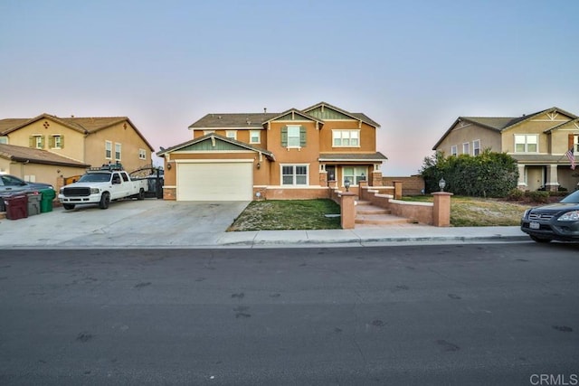 view of front of home with stucco siding, a garage, driveway, and a residential view