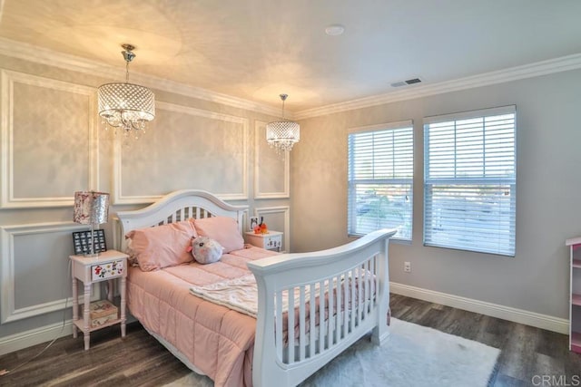 bedroom with a chandelier, dark wood finished floors, baseboards, and ornamental molding