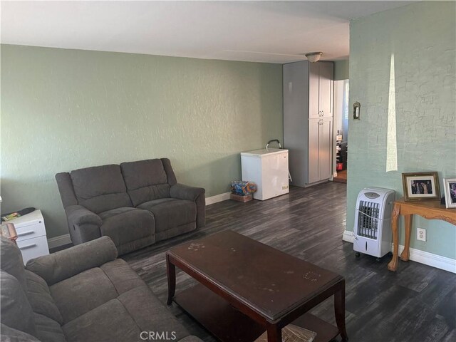10146 Alpaca St, South El Monte, CA 91733 - living area featuring heating unit, dark wood-style floors, baseboards, and a textured wall